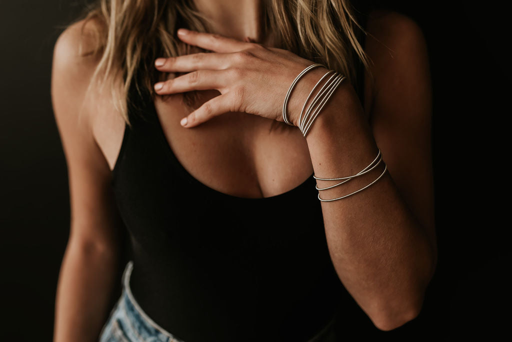 woman wearing silver guitar string bracelet